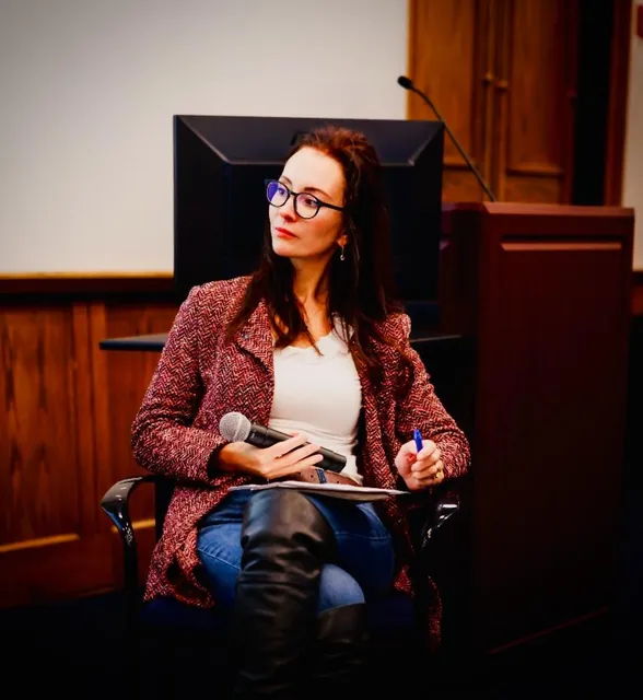 Adriana speaking with a microphone